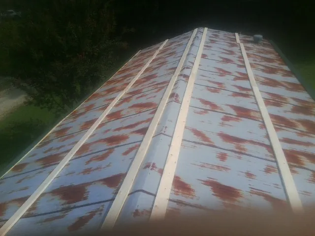 Rusted metal roof panels with new wood purlins before replacement — Storm Damage Roof Repair in Stephens City by Roofing Brothers