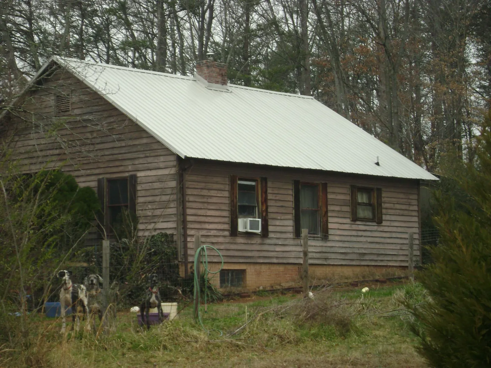 White metal roof on an old wood sided farmhouse, from a Metal Roof Installation job in Stephens City